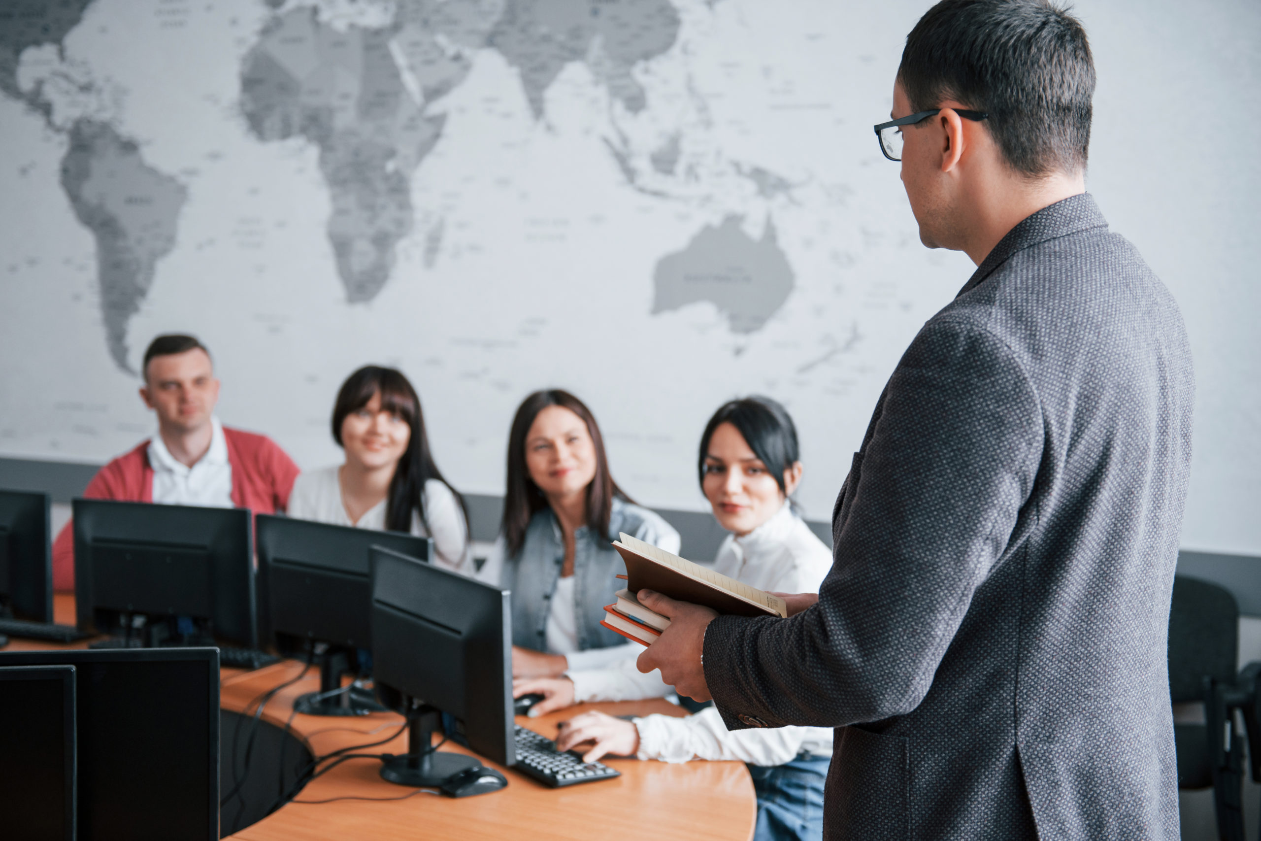 How is your deals. Group of people at business conference in modern classroom at daytime.