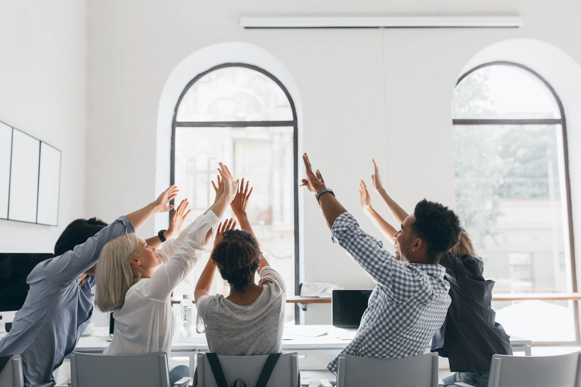 portrait-from-back-tired-students-stretching-after-long-work-indoor-photo-office-workers-fooling-around-during-meeting-conference-hall-with-big-windows_197531-3718